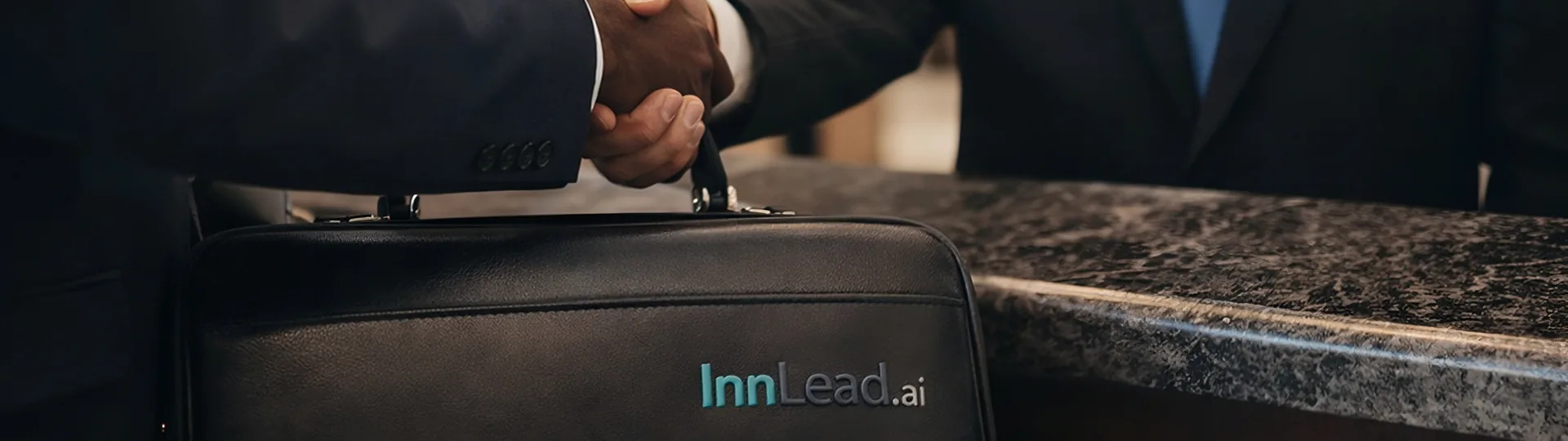 Premium embossed InnLead.ai leather card detail — professional hotel supplier branding and identity
